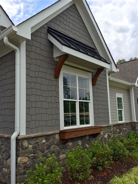 grey house with black awnings.